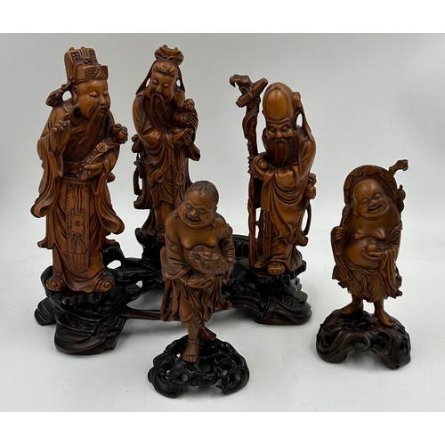 944 - A collection of oriental figures to include 5 x wooden carved figures on stands tallest 28cm and 3 x... 