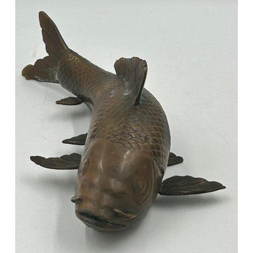 1228 - A bronze Japanese model of a Koi carp, 29cm long.