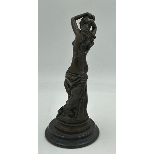 1230 - A bronze figure of a semi naked classical female on a marble base. 33cm h.