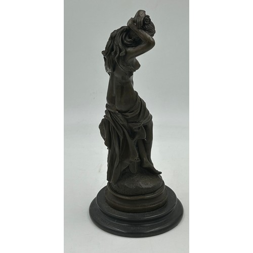 1230 - A bronze figure of a semi naked classical female on a marble base. 33cm h.