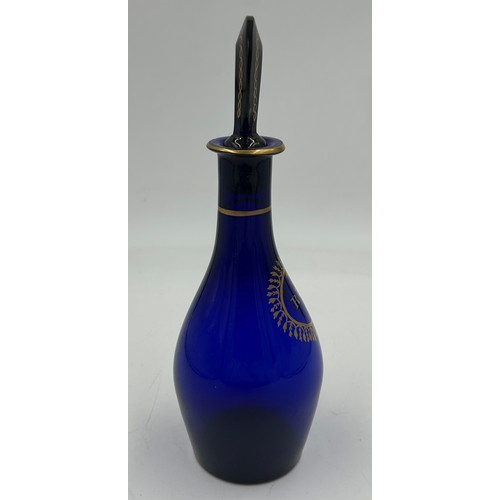 497 - A Bristol Blue 19thC Rum Decanter with gilt pattern and lettering,  25cm to top of stopper.