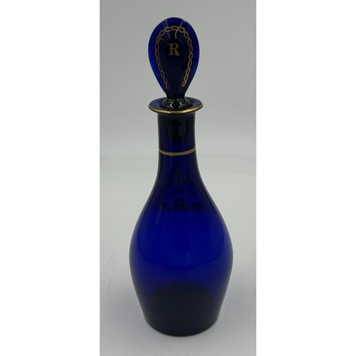 497 - A Bristol Blue 19thC Rum Decanter with gilt pattern and lettering,  25cm to top of stopper.