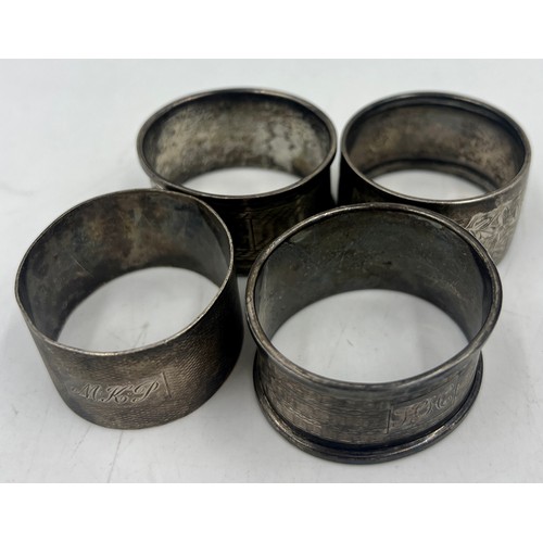 831 - Four hallmarked silver napkin rings. Various dates and makers. Total weight 65.4gm.