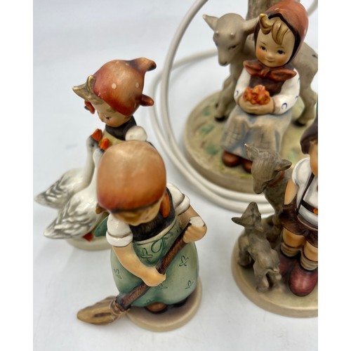 440 - A Hummel pottery table lamp, 19cm high to fitting and four various Hummel figures.