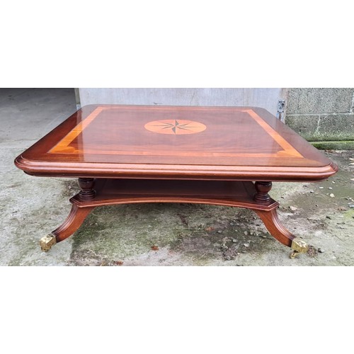 41 - A good quality inlaid mahogany coffee table with brass castors. 44cm h x 122cm x 122cm