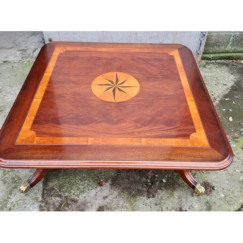 41 - A good quality inlaid mahogany coffee table with brass castors. 44cm h x 122cm x 122cm