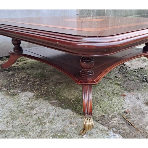 41 - A good quality inlaid mahogany coffee table with brass castors. 44cm h x 122cm x 122cm