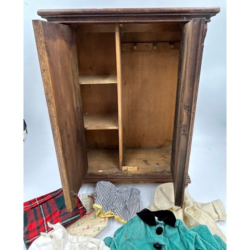 1127 - A stained pine doll’s wardrobe with bun feet and interior shelves and hooks 44.5cm h x 34cm w x 16.5... 