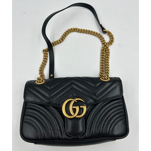 877 - A genuine Marmont Gucci black leather bag with gold coloured hardware, comes with dust bag.