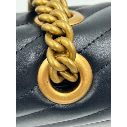 877 - A genuine Marmont Gucci black leather bag with gold coloured hardware, comes with dust bag.