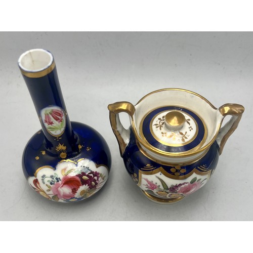 447 - A lidded pot with hand painted floral panel together with a blue, gilt and floral painted vase.