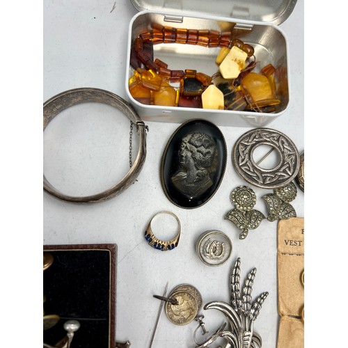 515 - A quantity of 19th and 20thC jewellery to include silver bangle, tie pins, buttons on original card,... 