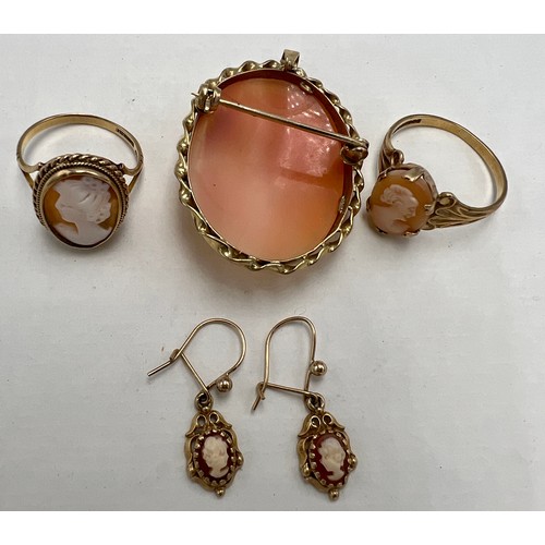 634 - A shell cameo brooch with 9 carat gold surround, two 9 carat gold cameo rings and a pair of earrings... 