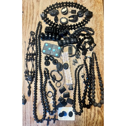 636 - A quantity of Whitby jet jewellery to include bracelets, buttons, buckle with turquoise stones, cruc... 