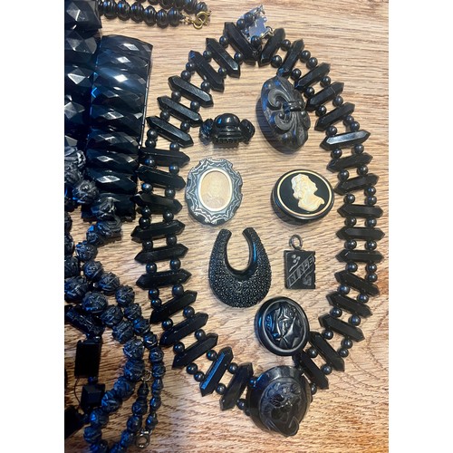 636 - A quantity of Whitby jet jewellery to include bracelets, buttons, buckle with turquoise stones, cruc... 