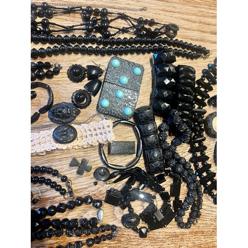 636 - A quantity of Whitby jet jewellery to include bracelets, buttons, buckle with turquoise stones, cruc... 