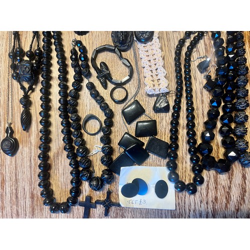 636 - A quantity of Whitby jet jewellery to include bracelets, buttons, buckle with turquoise stones, cruc... 