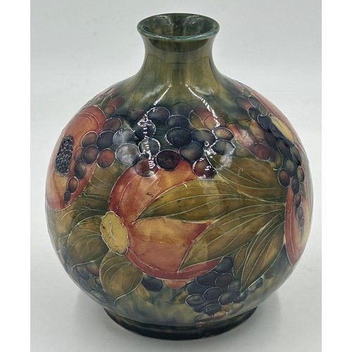 450 - A Moorcroft pottery Pomegranate vase design on ochre ground, signed W Moorcroft in green, made for L... 