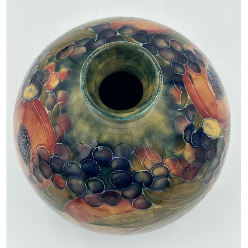 450 - A Moorcroft pottery Pomegranate vase design on ochre ground, signed W Moorcroft in green, made for L... 