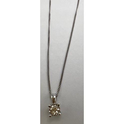 641 - A diamond set pendant set in 9 carat white gold suspended on an 18 carat white gold chain.  Chain 40... 