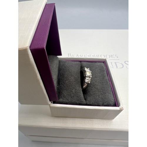 643 - A three stone diamond ring set in platinum. Size I. Weight 4gm.