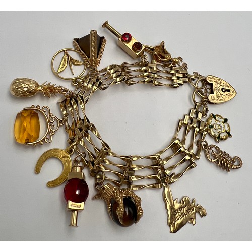 645 - A 9 carat gold charm bracelet and various charms. All hallmarked 9 carat gold apart from horse shoe ... 