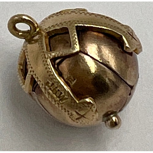 647 - A 9 carat gold and silver Masonic ball pendant opening to reveal hieroglyphics. Weight 6.9gm.