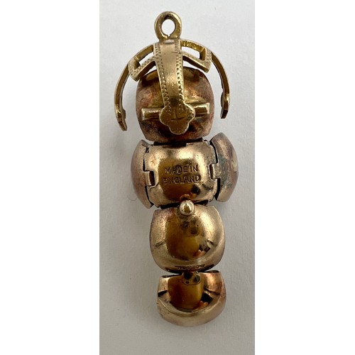 647 - A 9 carat gold and silver Masonic ball pendant opening to reveal hieroglyphics. Weight 6.9gm.