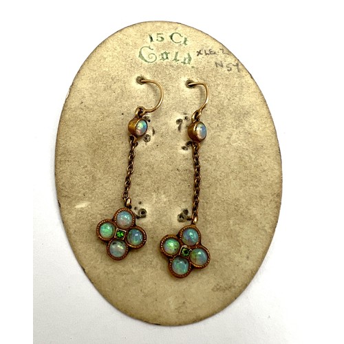 653 - Victorian 15 carat gold earrings set with opals and green stone. On original presentation card. Weig... 