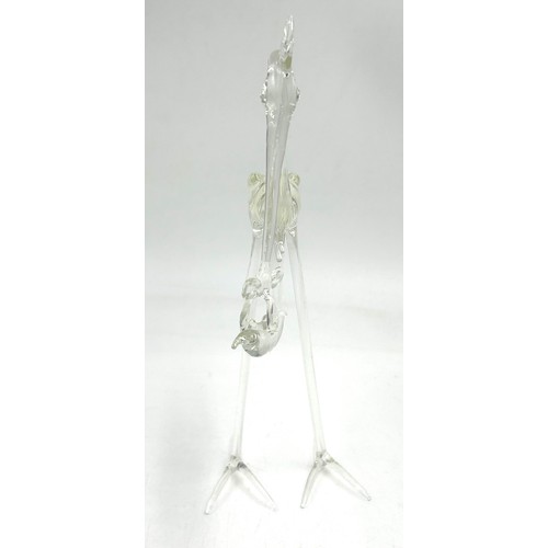 499 - A Vintage glass Stork carrying a baby in a basket. 20cm h.