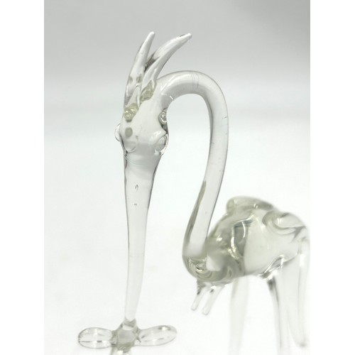 499 - A Vintage glass Stork carrying a baby in a basket. 20cm h.