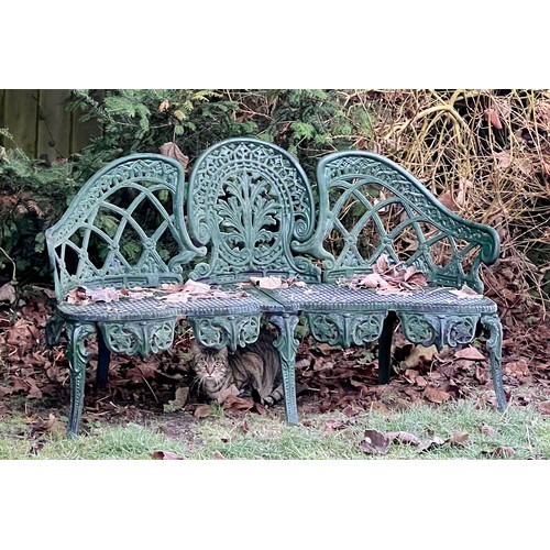 13 - A decorative green metal garden seat. 130 w x 76cm h.