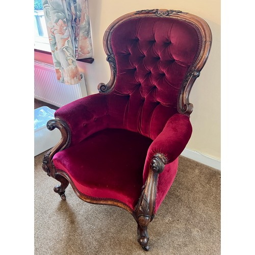 71 - A 19thC button backed armchair with cabriole legs and swept arms upholstered in red velvet. 105 h x ... 