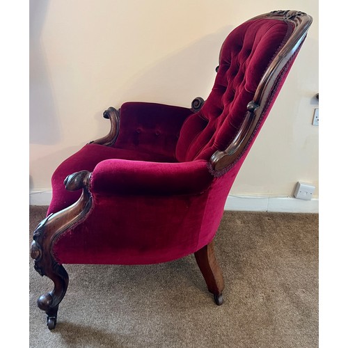 71 - A 19thC button backed armchair with cabriole legs and swept arms upholstered in red velvet. 105 h x ... 