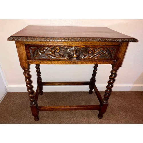 72 - An oak side table on barley twist supports with single drawer to front, animal head pull and carving... 