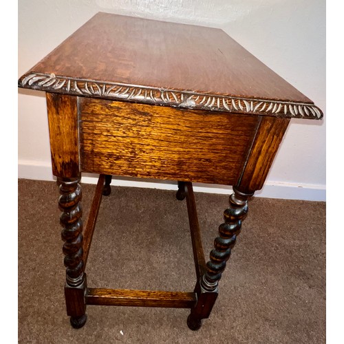 72 - An oak side table on barley twist supports with single drawer to front, animal head pull and carving... 