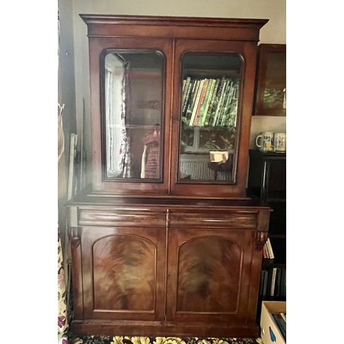 83 - A 19thC mahogany bookcase over cupboard base, 2 glazed doors over 2 door, 2 drawer base with cellare... 