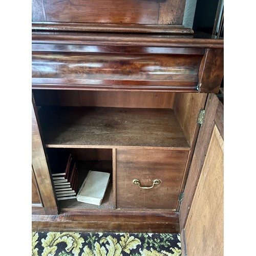 83 - A 19thC mahogany bookcase over cupboard base, 2 glazed doors over 2 door, 2 drawer base with cellare... 