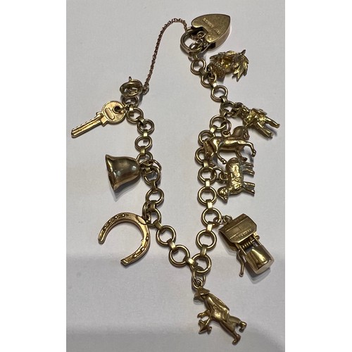 658 - A 9 carat gold charm bracelet with 9 carat gold charms,  bell unmarked. Total weight 22gm.