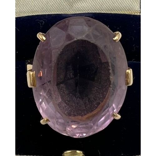 659 - A 9 carat gold ring set with large paste purple stone. Weight 10gm. Size X.