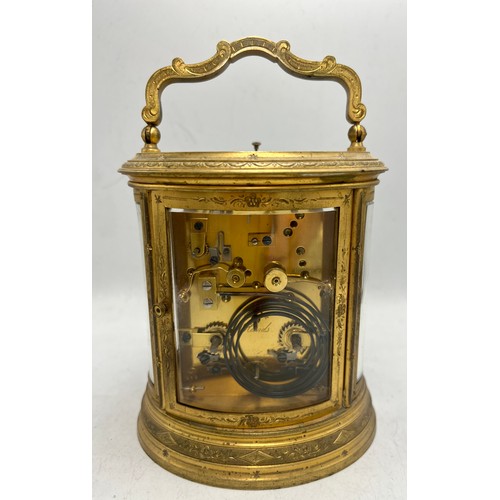 996 - A 19thC brass repeater carriage clock with French movement and alarm. 19cm h to top of handle.