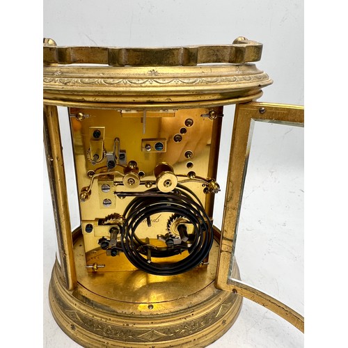 996 - A 19thC brass repeater carriage clock with French movement and alarm. 19cm h to top of handle.