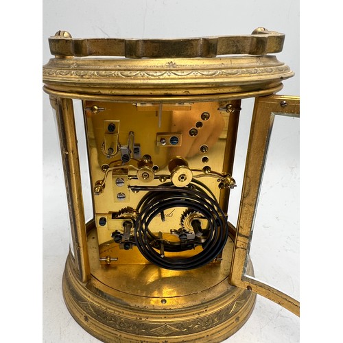 996 - A 19thC brass repeater carriage clock with French movement and alarm. 19cm h to top of handle.