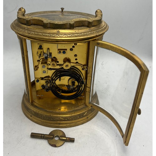 996 - A 19thC brass repeater carriage clock with French movement and alarm. 19cm h to top of handle.