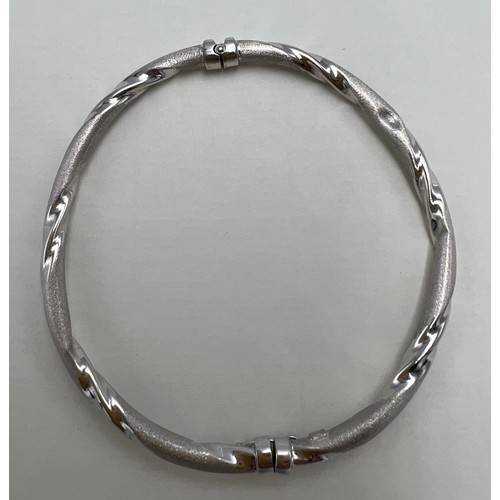 661 - A nine carat white gold bangle. Weight 5.4gm.