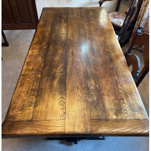 88 - An oak table with single stretcher together with 6 ladder back chairs and two carvers. Table 182 l x... 