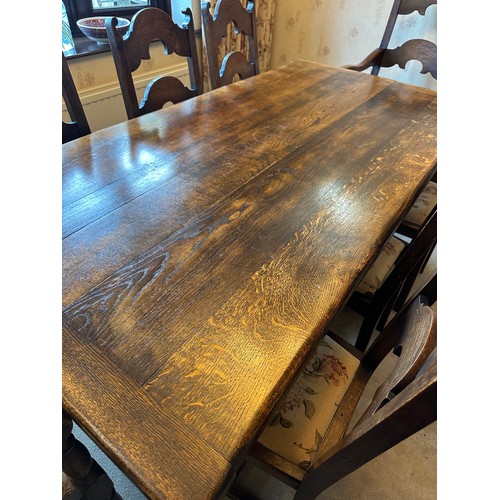 88 - An oak table with single stretcher together with 6 ladder back chairs and two carvers. Table 182 l x... 