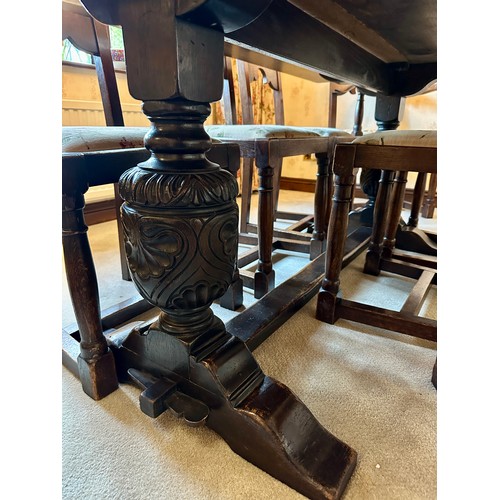 88 - An oak table with single stretcher together with 6 ladder back chairs and two carvers. Table 182 l x... 