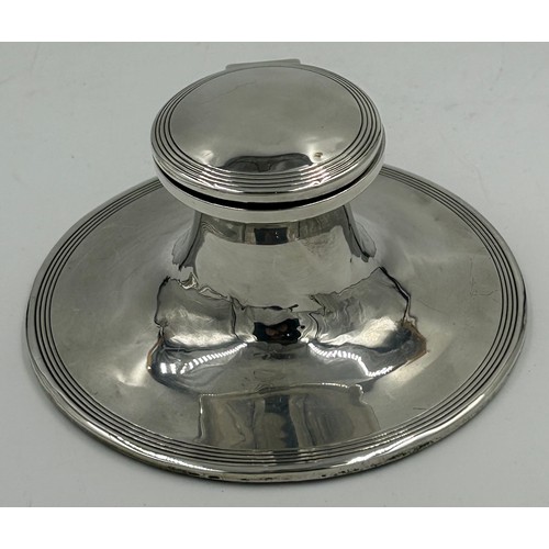 838 - A hallmarked silver inkwell with glass liner Birmingham 1906, makers mark rubbed together with a ser... 