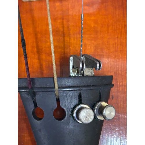 951 - A 19thC cased violin, no labels, back measures 37cm together with another violin and three bows.